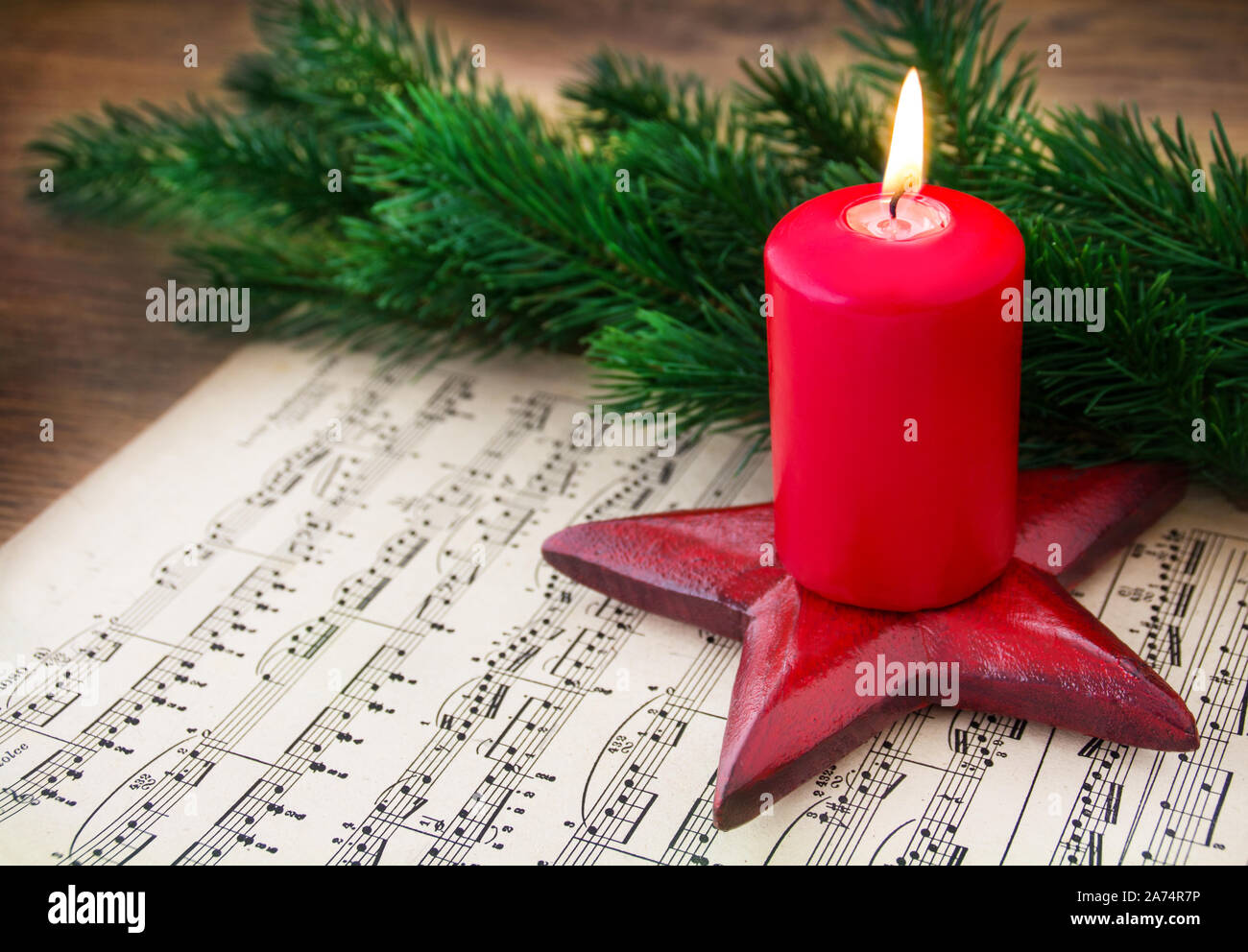 Christmas Music Sheet Music with Burning Candle Stock Photo - Alamy