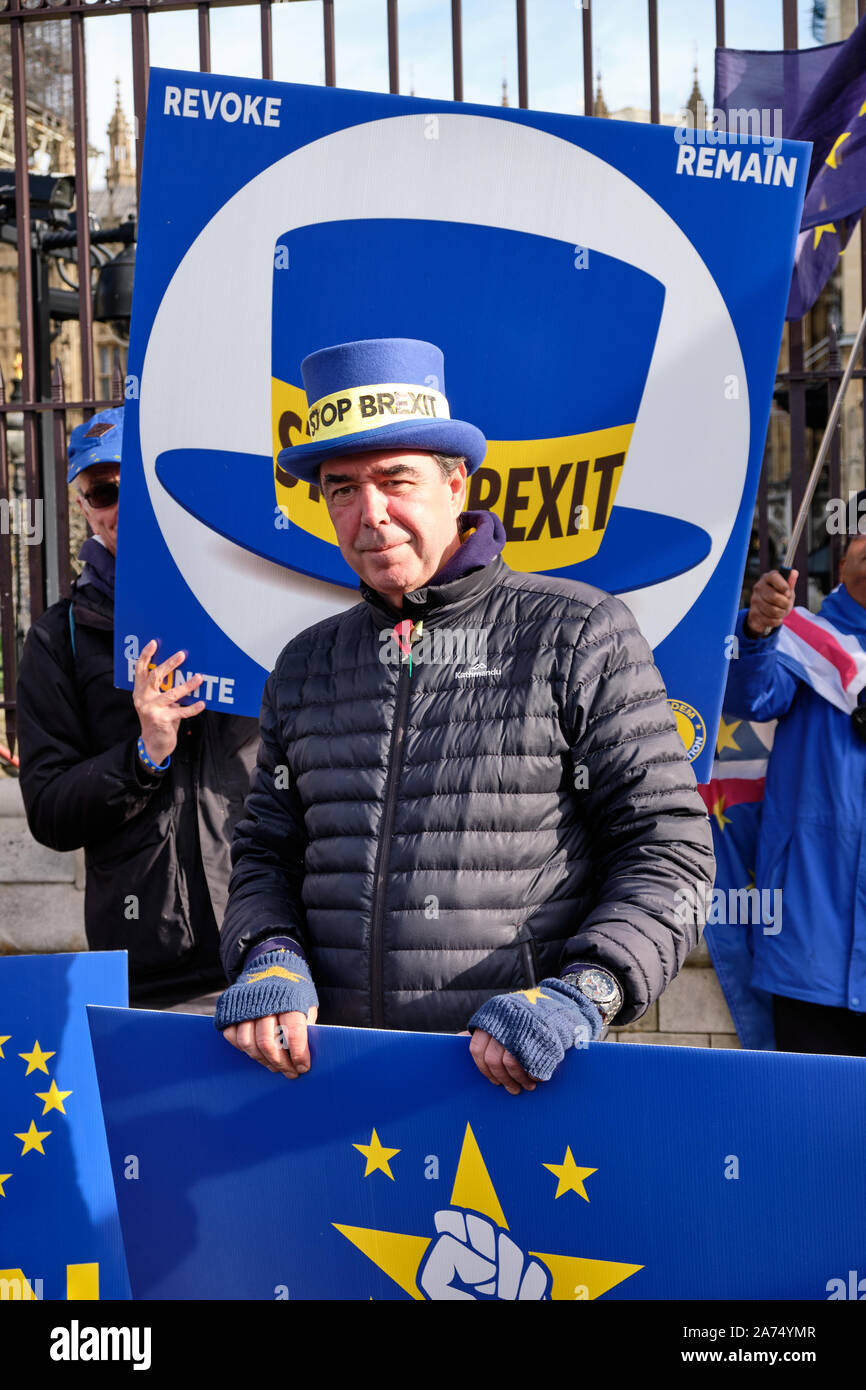 Westminster, England, UK. 30th October 2019.  Remain protesters in front of the House of Commons celebrating another delay in Brexit implementation, highlighting that the imposed deadline of Halloween will go by with the UK still in the European Union, contrarily to promises by the Prime Minister. Steve Bray, Mr.Stop Brexit, smiling in front of hat sign for which he is famous for.  Credit: JF Pelletier/Alamy Live News. Stock Photo
