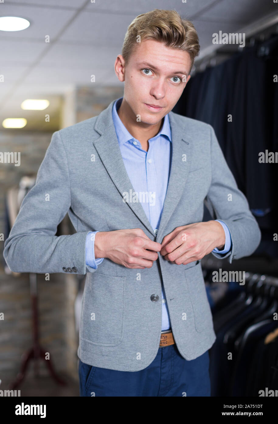 Portrait of man costumer trying business style jacket in the shop Stock ...