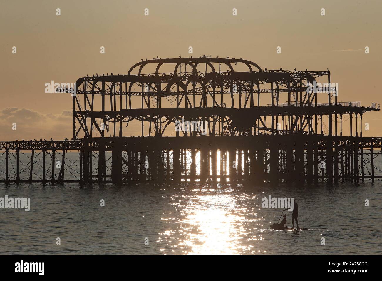 As the temperatures rise inside Westminster this evening as the Brexit voting hots up, in Brighton it's chilled as locals enjoy the Indian Summer padd Stock Photo