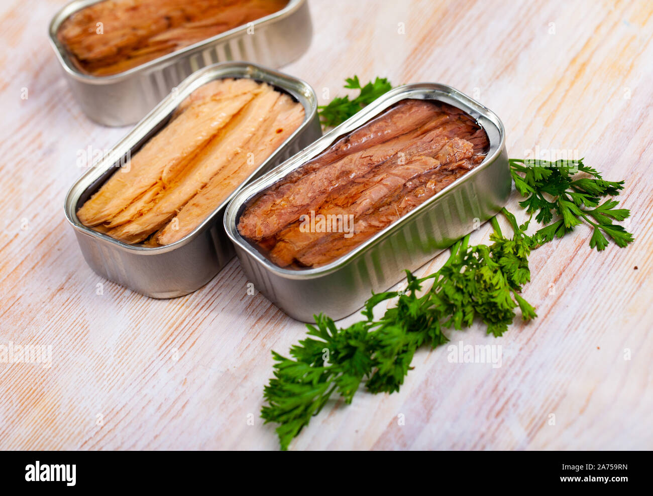 Canned seafood, Andalusian melva fish fillets preserved in oil on wooden table Stock Photo
