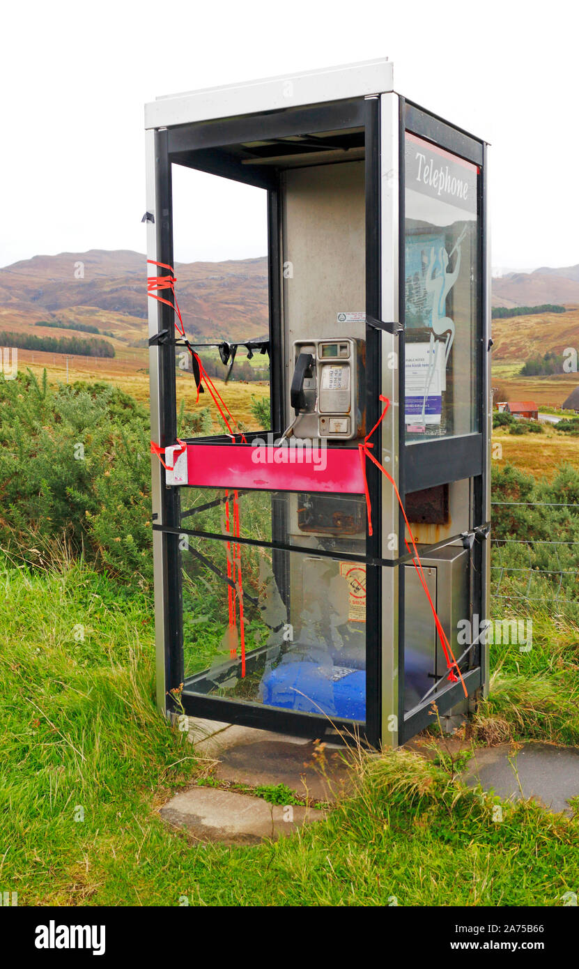An apparently vandalised telephone box in a remote location in the North West Highlands in Assynt, Scotland, United kingdom, Europe. Stock Photo