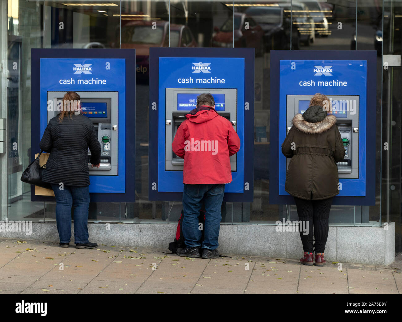 People using cash machines in Halifax in Yorkshire, as a think tank says the Conservatives will have to target traditional Labour voters from regional towns in order to win the general election. Stock Photo