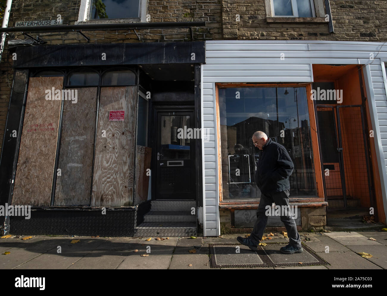 A man walks past a closed shop in Halifax in Yorkshire, as a think tank says the Conservatives will have to target traditional Labour voters from regional towns in order to win the general election. PA Photo. Picture date: Wednesday October 30, 2019. The Conservatives will have to target traditional Labour voters from regional towns such as Workington in order to win the Christmas general election, according to a think tank. The group urged the party to target towns including Halifax, Warrington, Wigan and Workington in order to gain these key regional seats. Photo credit should read: Danny La Stock Photo