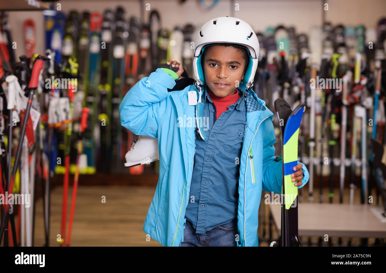 Tween boy in casual outfit cuts stick 