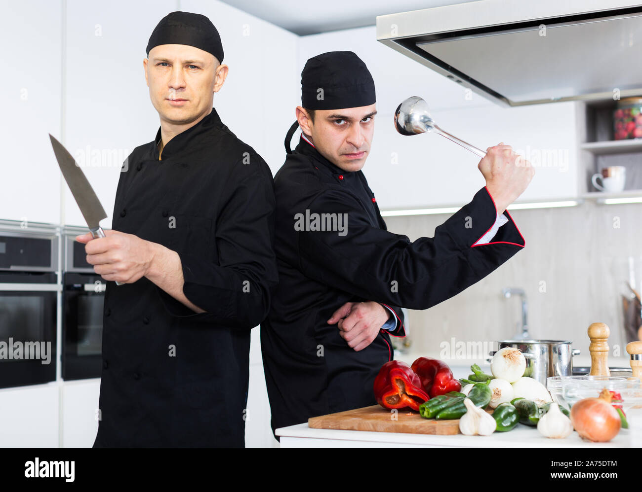 Men Cooking Roles Portrait of men cook who are standing on their work place in the ...