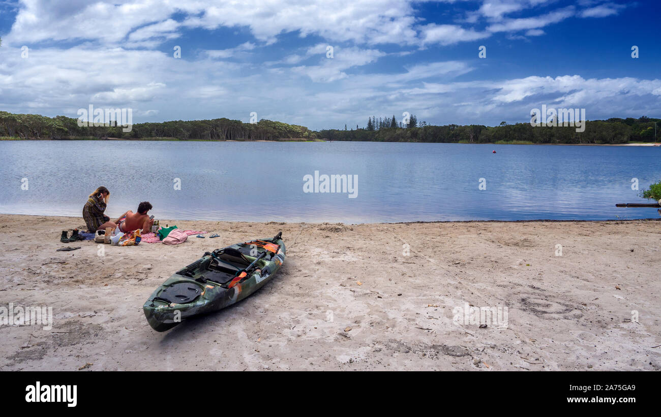 Couple picnic lakeside with Kayak Stock Photo