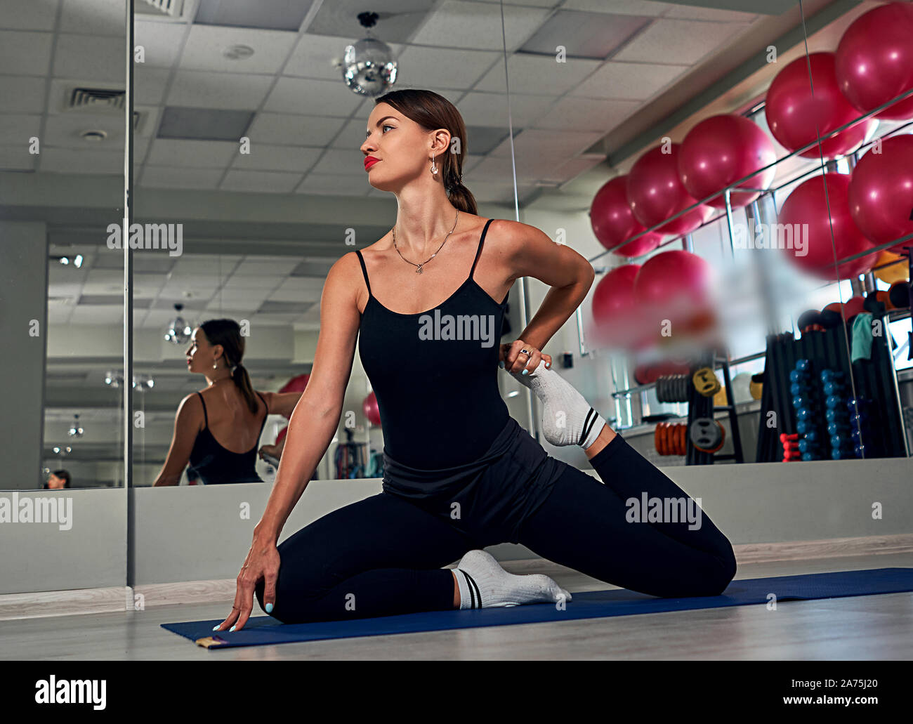girl doing stretching in the gym Stock Photo