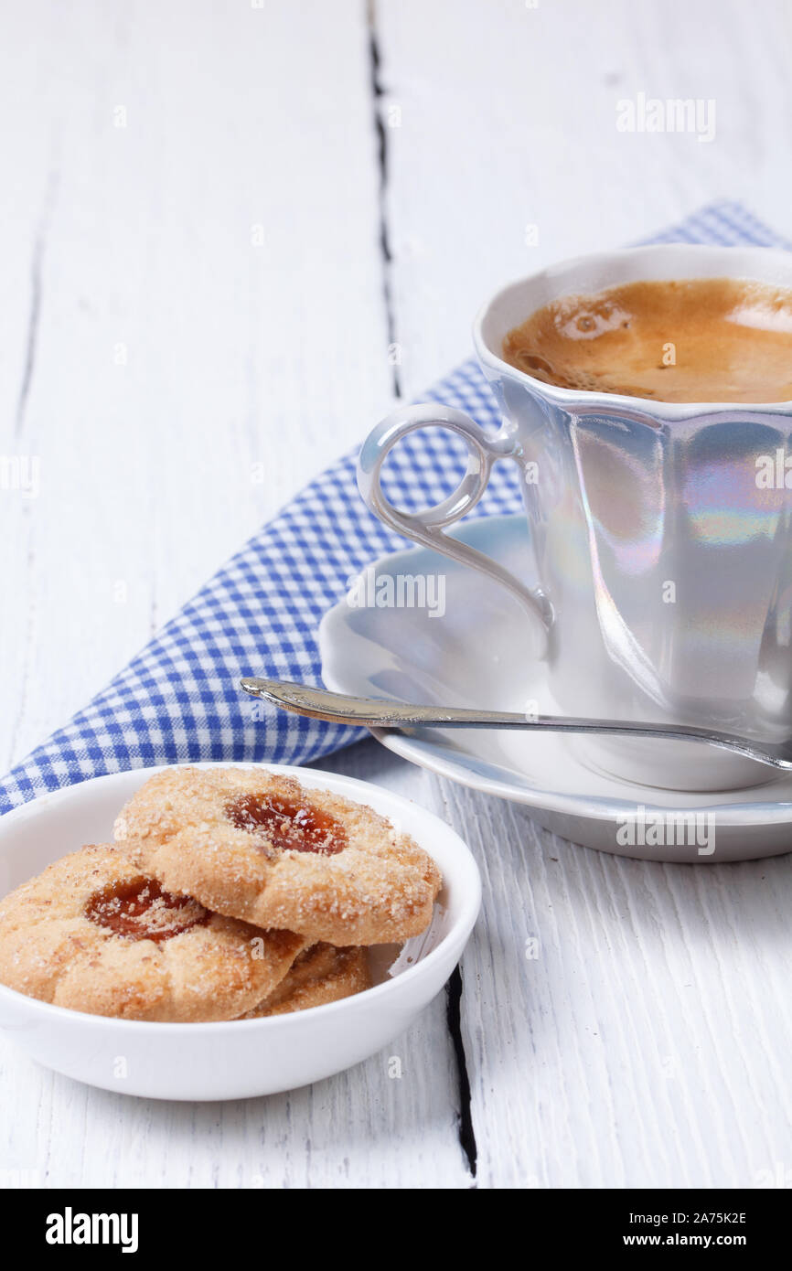 Coffee cup and cookies on a white vintage background. Stock Photo
