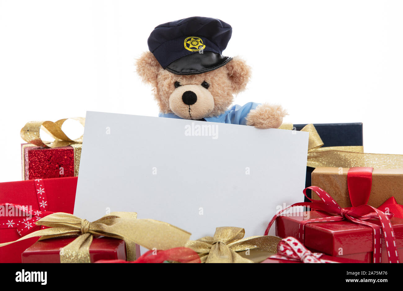 Police and christmas concept. Cute teddy bear in police officer uniform and xmas gift boxes isolated against white background, copy space Stock Photo