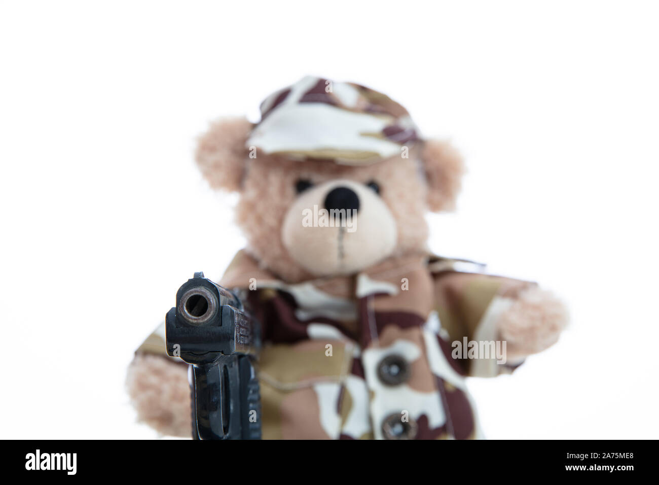 Army, military concept. Cute teddy bear in soldier uniform holding a