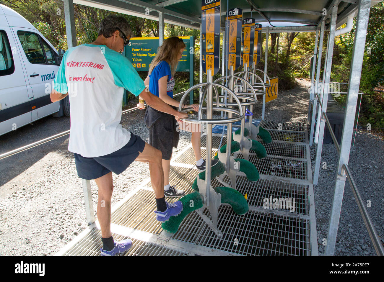 SCRUB YOUR SHOES AFTER KAURI FOREST TREKKING,NEW ZEALAND Stock Photo