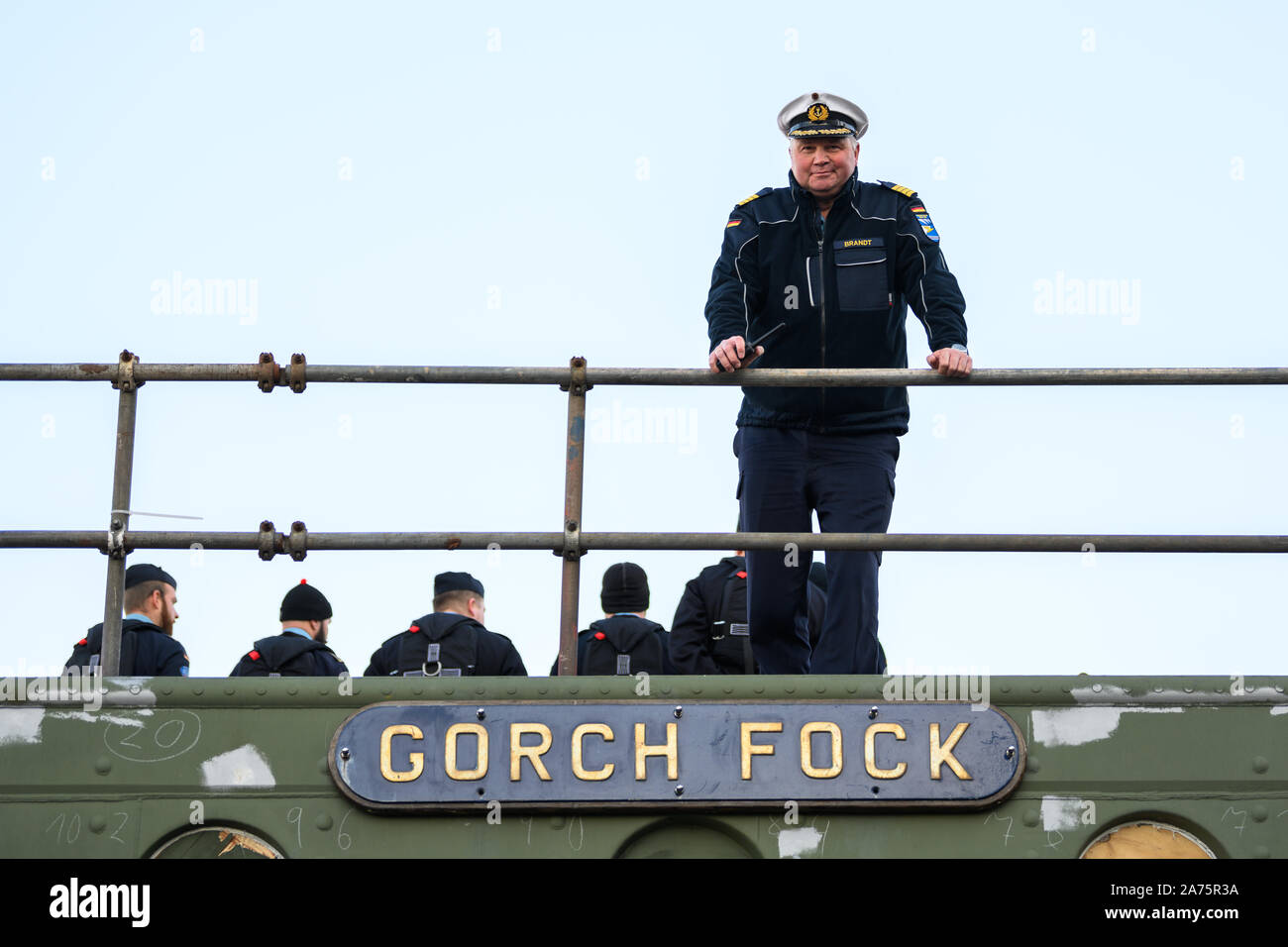Berne, Germany. 30th Oct, 2019. Nils Brandt, captain of the Gorch Fock, is standing on the partly renovated naval training ship 'Gorch Fock' shortly before the ship is towed from the Fassmer shipyard to the Lürssen shipyard. Lürssen acquires the insolvent Elsflether Werft, which is the general contractor for the repair of the naval glider. Credit: Mohssen Assanimoghaddam/dpa/Alamy Live News Stock Photo