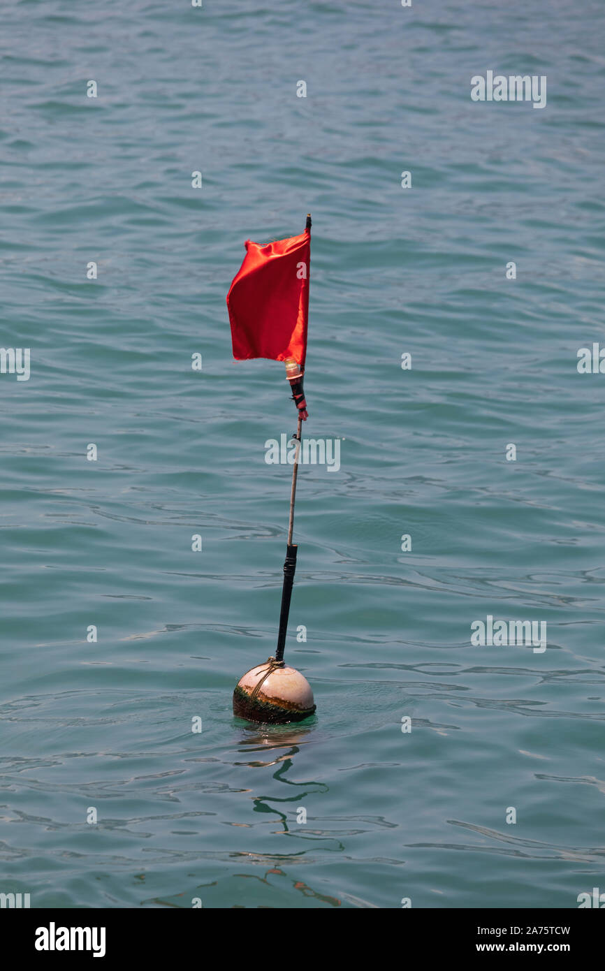 Floating Red Flag Mark in Harbour Water Warning Stock Photo - Alamy