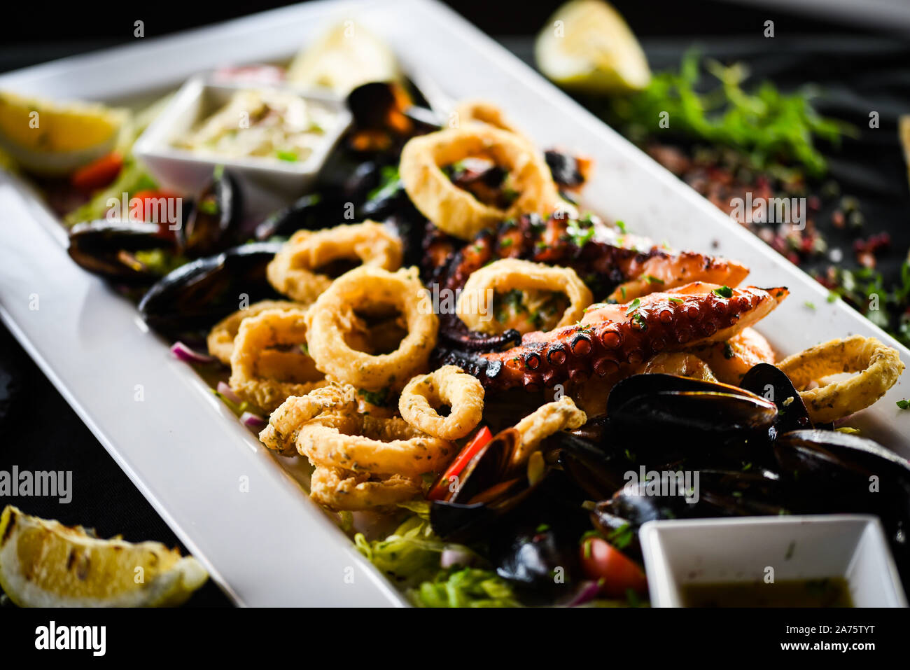 delicious mix fried seafood dish with octopus, shrimps, prawns, shells ...