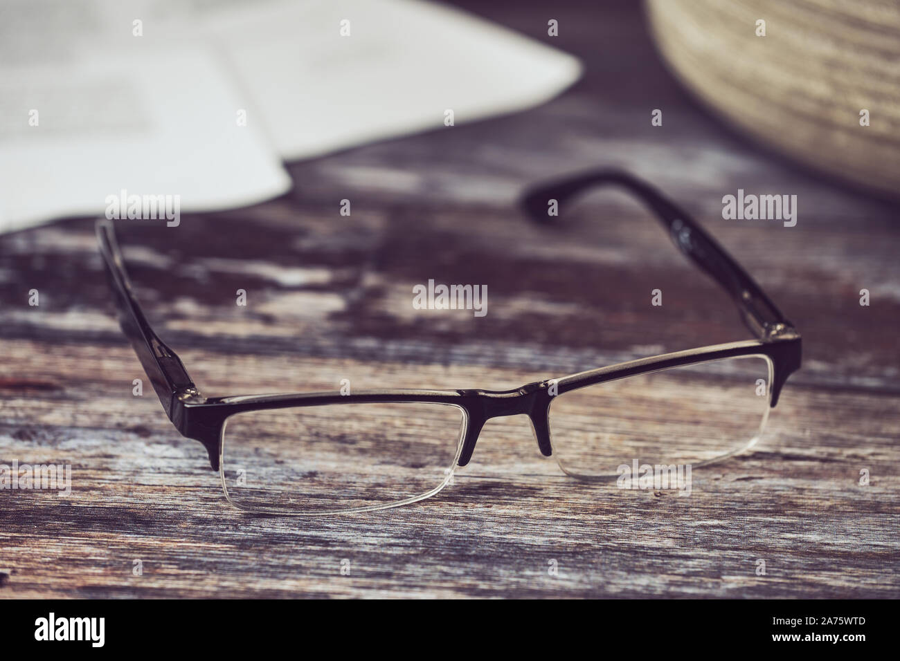 reading glasses lying on a wooden background Stock Photo