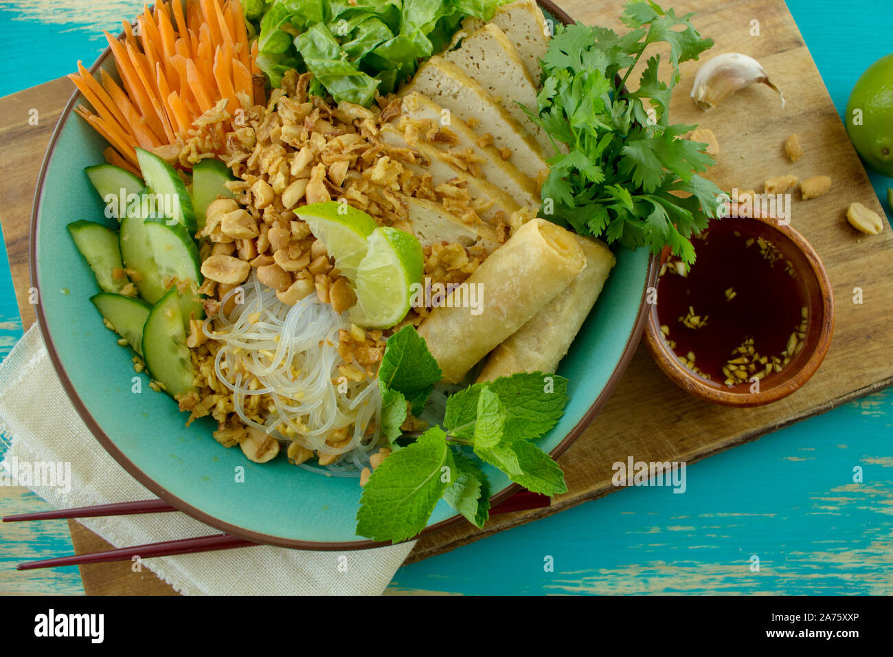 Food photography of a Vietnamese noodle salad bun chay with spring rolls fried tofu and