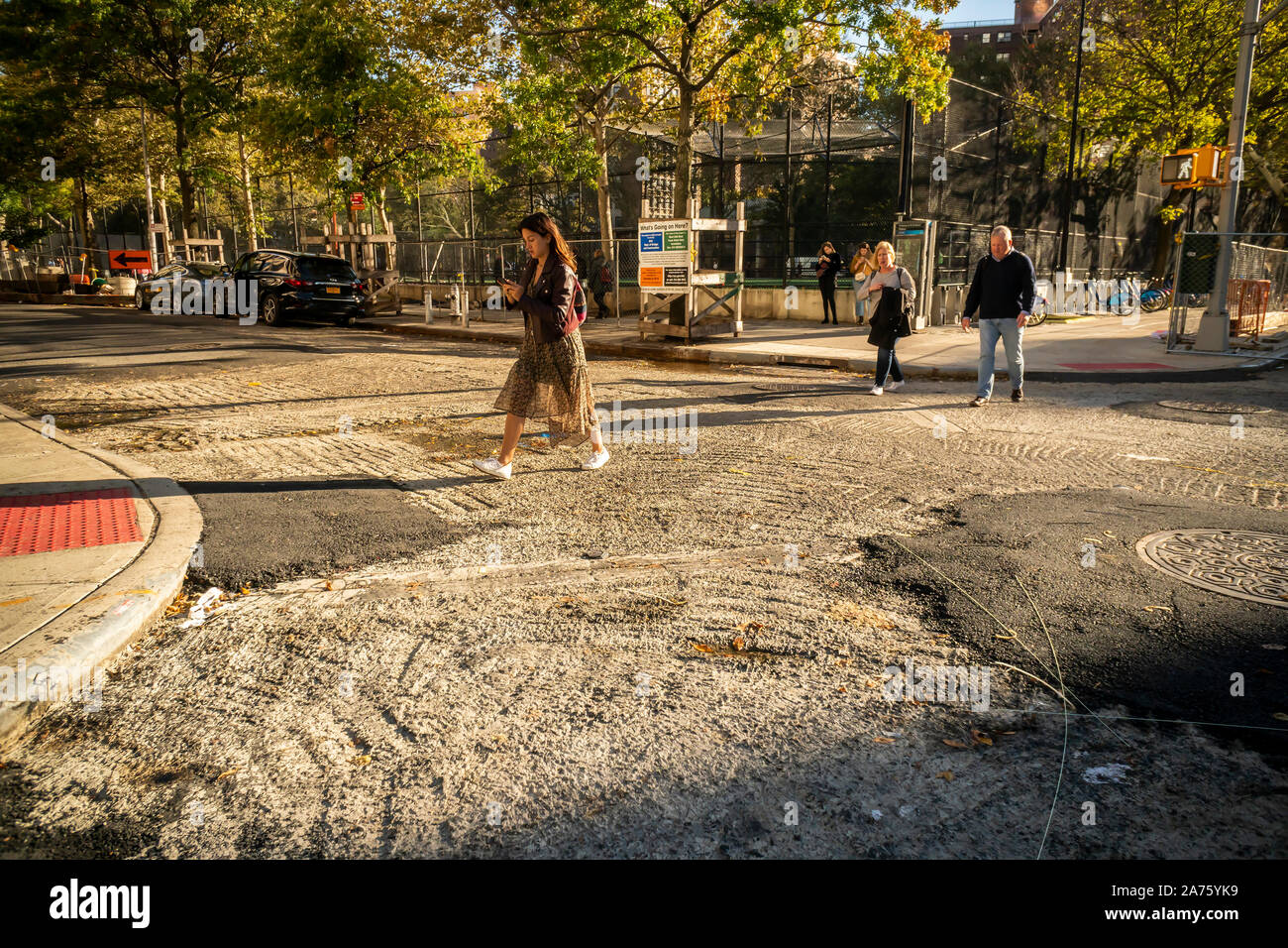 Pedestrians cross an intersection undergoing repaving in the Chelsea neighborhood of New York on Wednesday, October 23, 2019. (© Richard B. Levine) Stock Photo