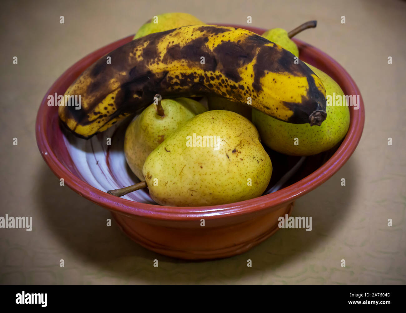 Bartlett pears ripening in a bowl with a banana in New York on Saturday
