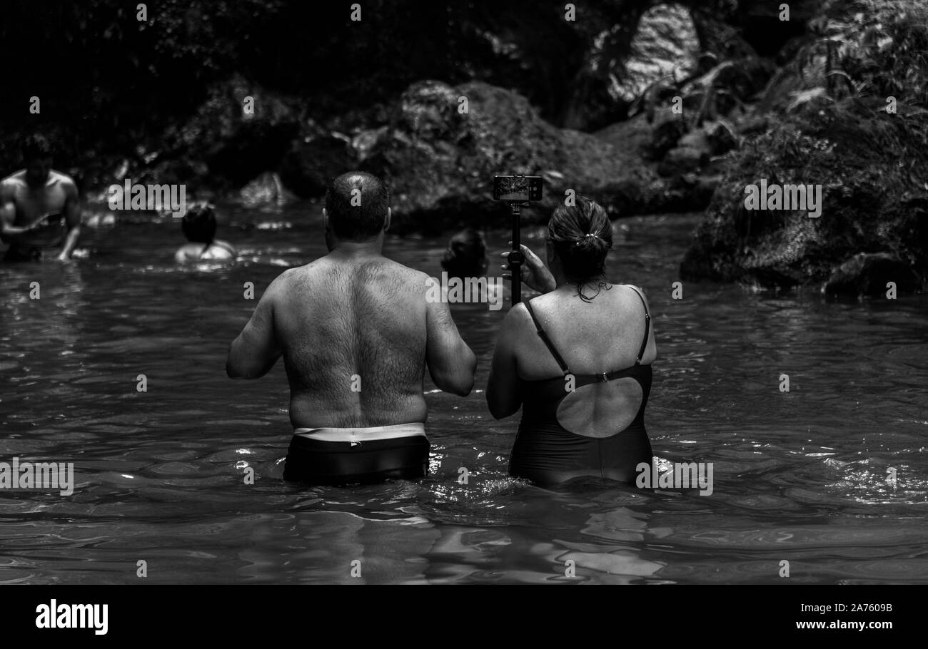A black and white picture of a middle-aged couple at the Caldeira Velha thermal waters complex. Stock Photo