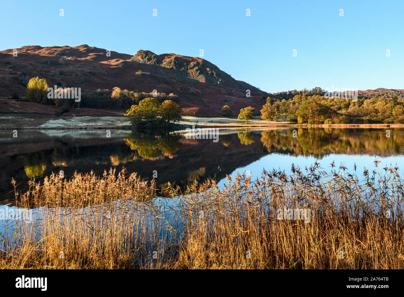 Looking across Rydal Water towards Loughrigg on a glorious autumn morning Stock Photo