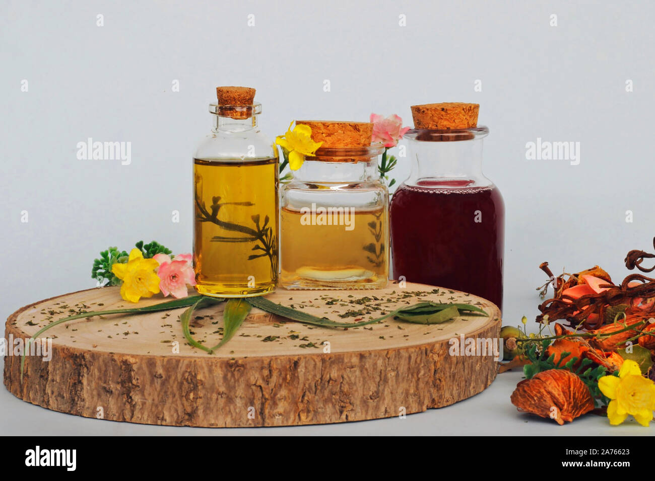 Natural Medicine: Selection of 3 jars with essential oils with wildflowers and plants. Alternative Medicine that respects the environment. Stock Photo