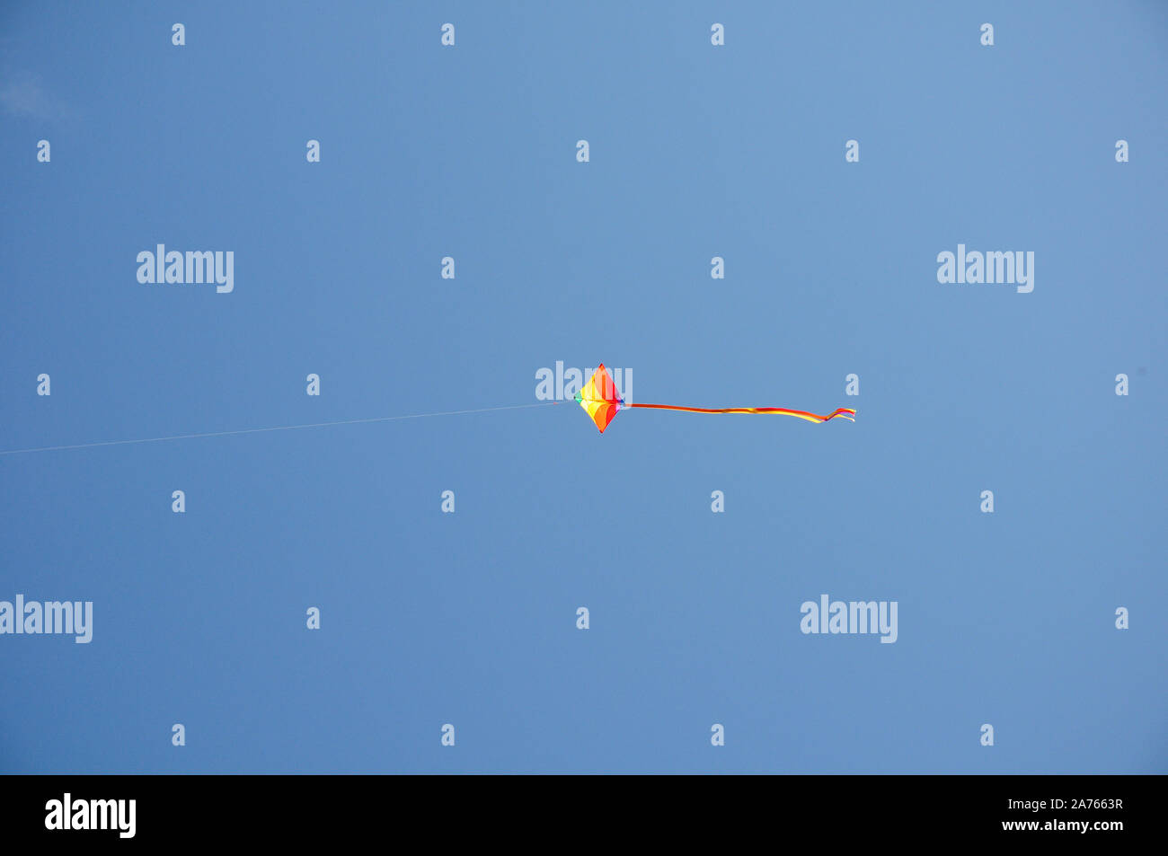 Kite flying in blue sky. Stock Photo