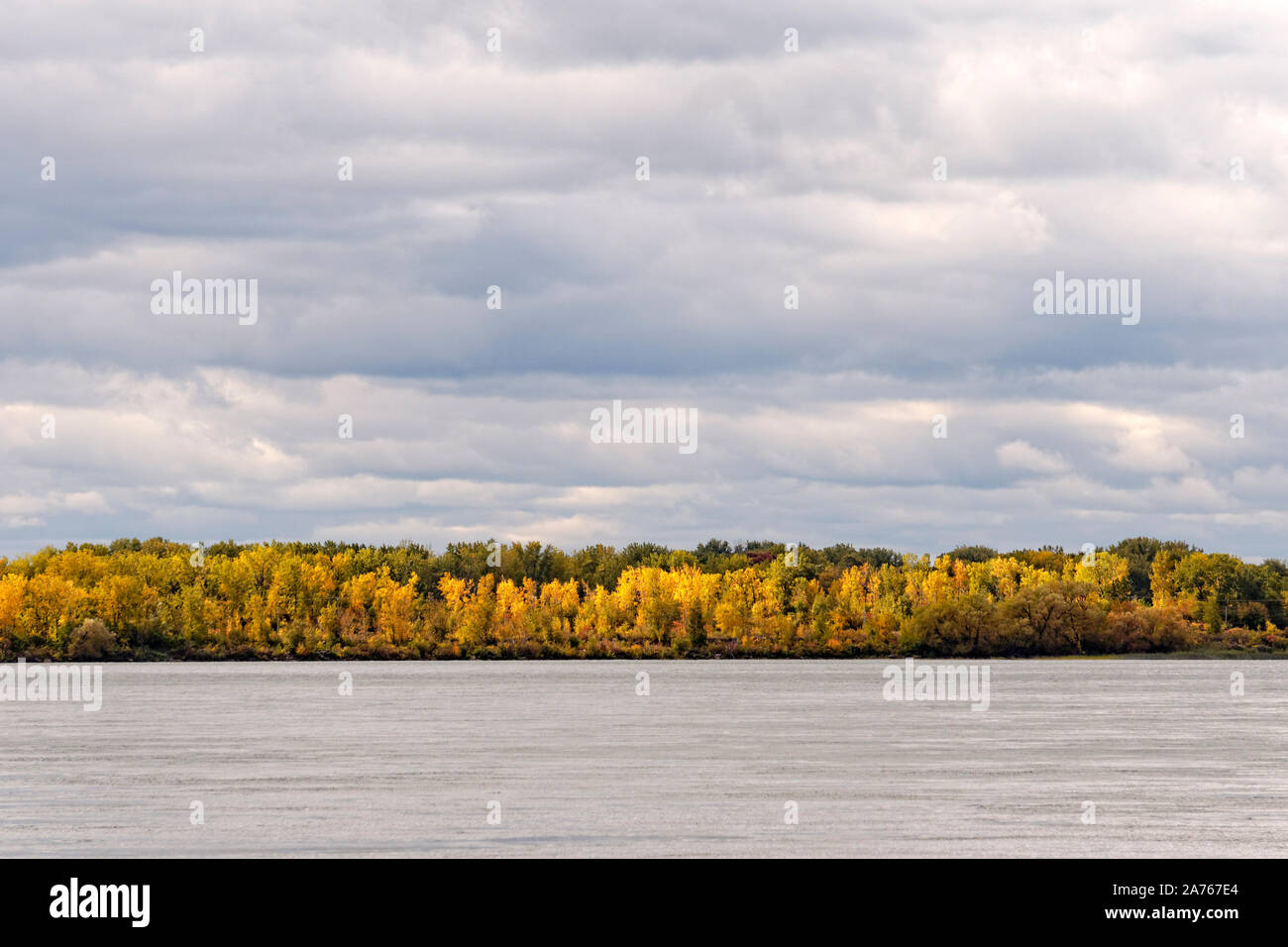 View of the Saint Lawrence River and colorful fall foliage on the south shore, Lasalle, Montreal, Quebec, Canada Stock Photo