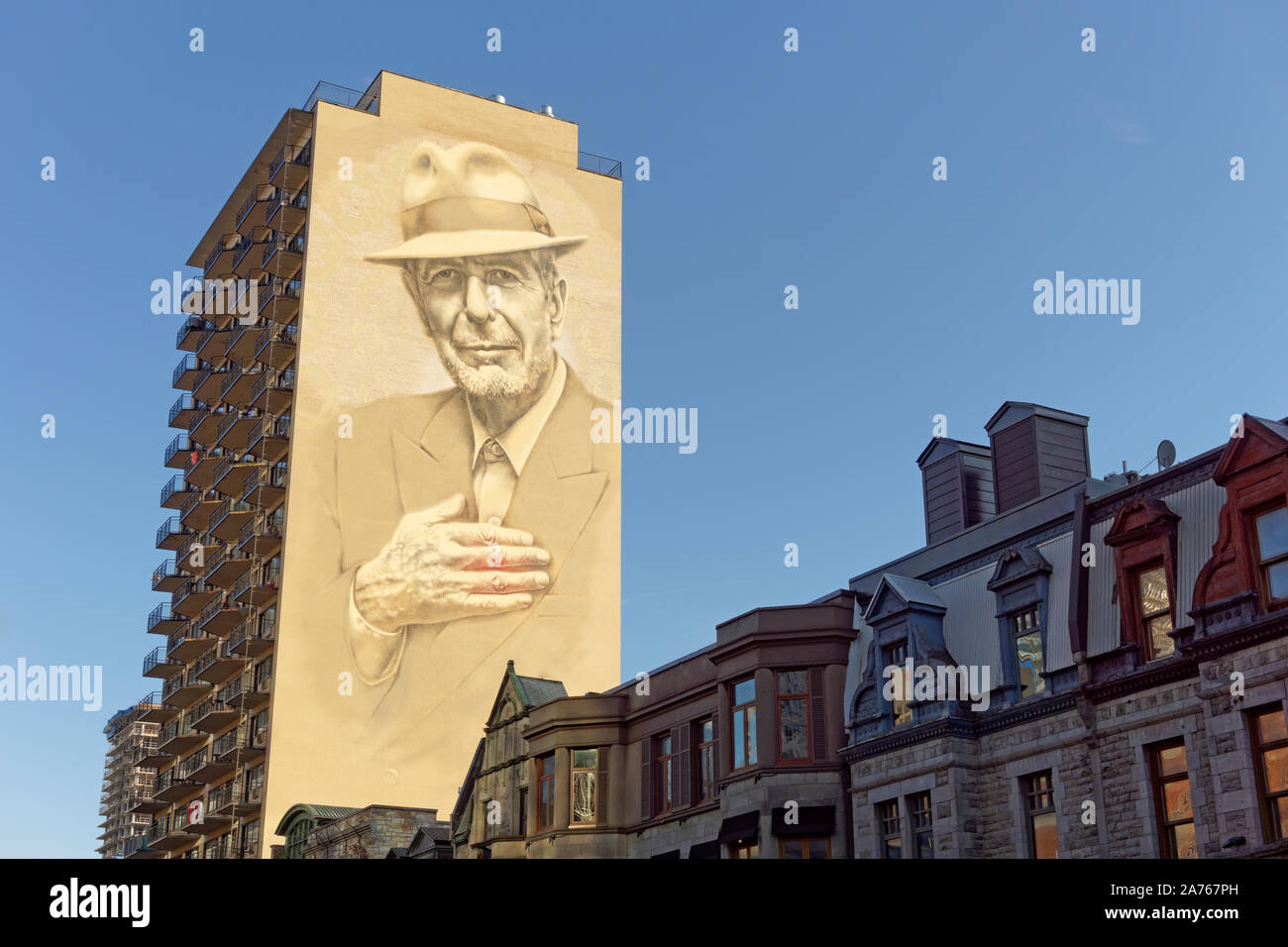 Huge Leonard Cohen mural painted on the side of a tall building on Crescent Street in downtown Montreal, Quebec, Canada Stock Photo