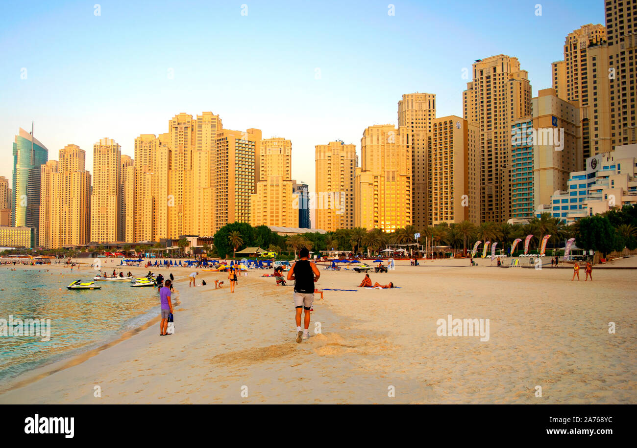 Dubai / UAE - October 17, 2019: JBR. Panoramic view of Jumeirah Beach Residence skyscrapers and urban beach with people. Stock Photo