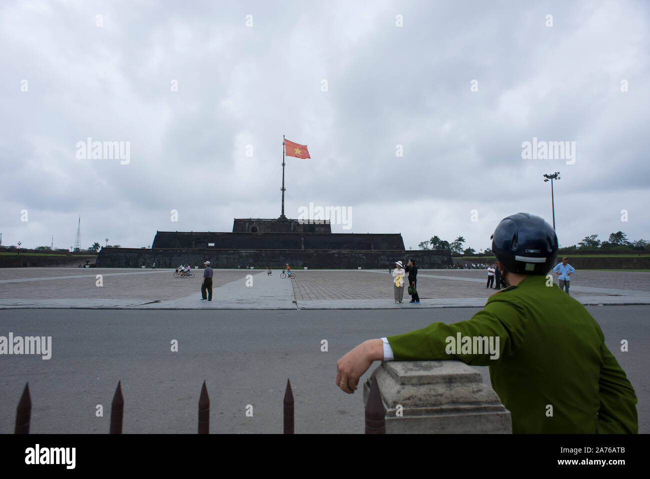 Hue, Thua Thien-Hue, Vietnam - February 27, 2011:  Vietnamese guard observing the people around the Flag Tower (Cot Co) Stock Photo