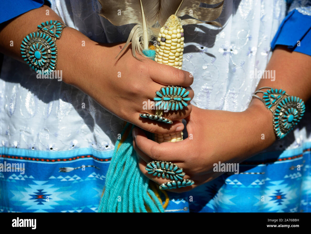 A young Native American woman from the Zuni Pueblo in New Mexico wears traditional petit point cluster turquoise and silver jewelry in Santa Fe, NM Stock Photo