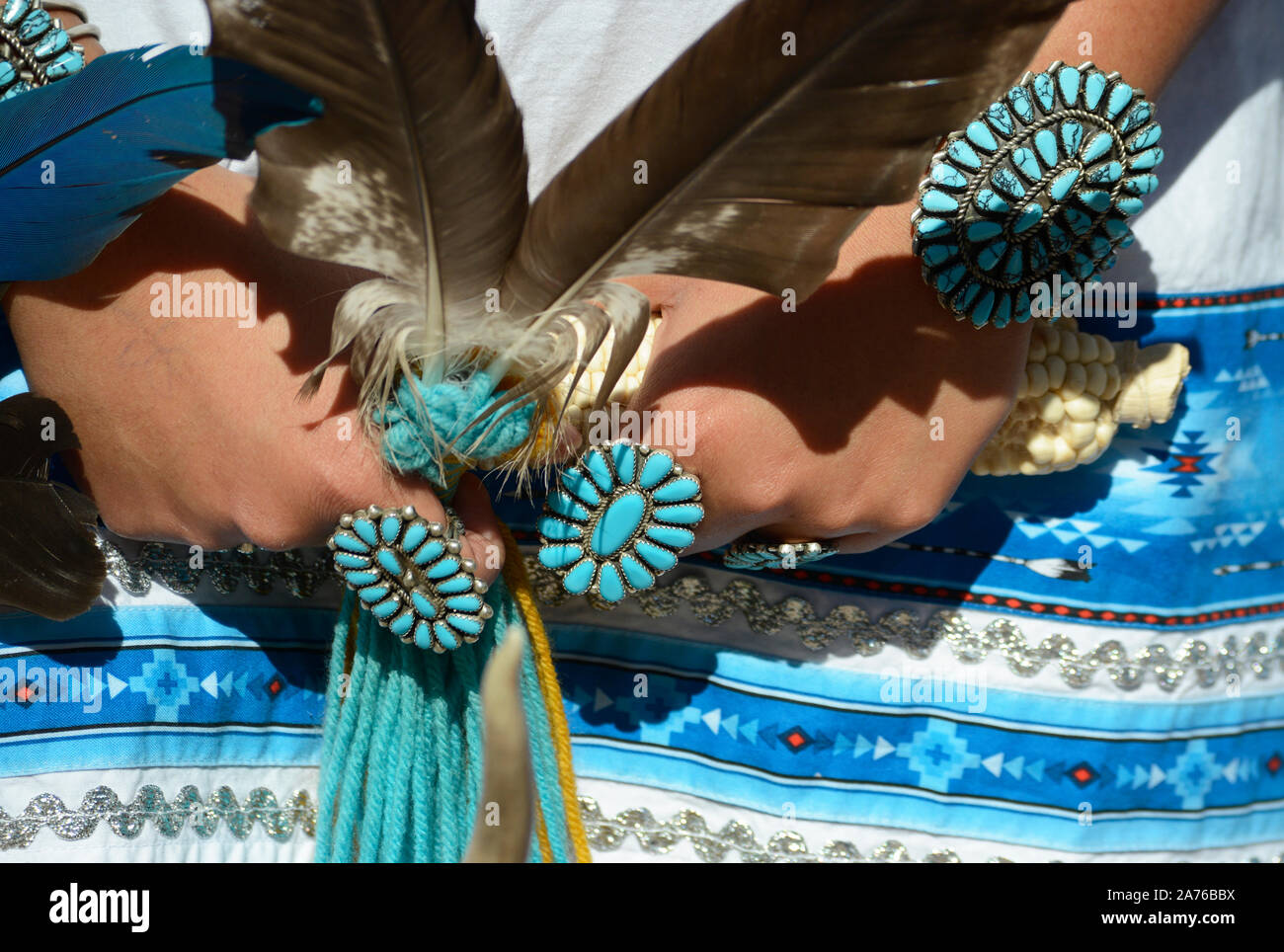 A young Native American woman from the Zuni Pueblo in New Mexico wears traditional petit point cluster turquoise and silver jewelry in Santa Fe, NM Stock Photo
