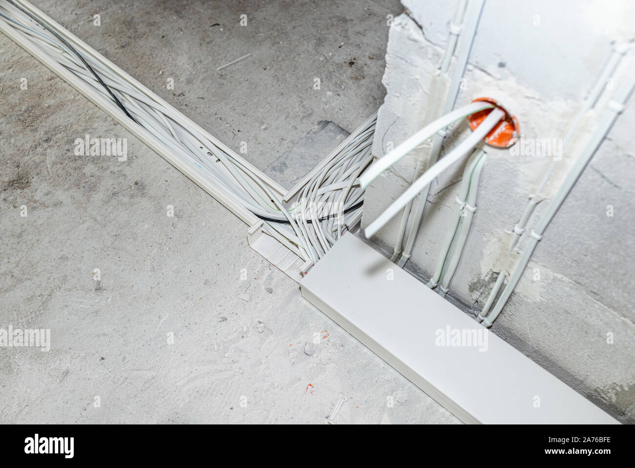 Layed installation of electric cables on the floor in a newly built