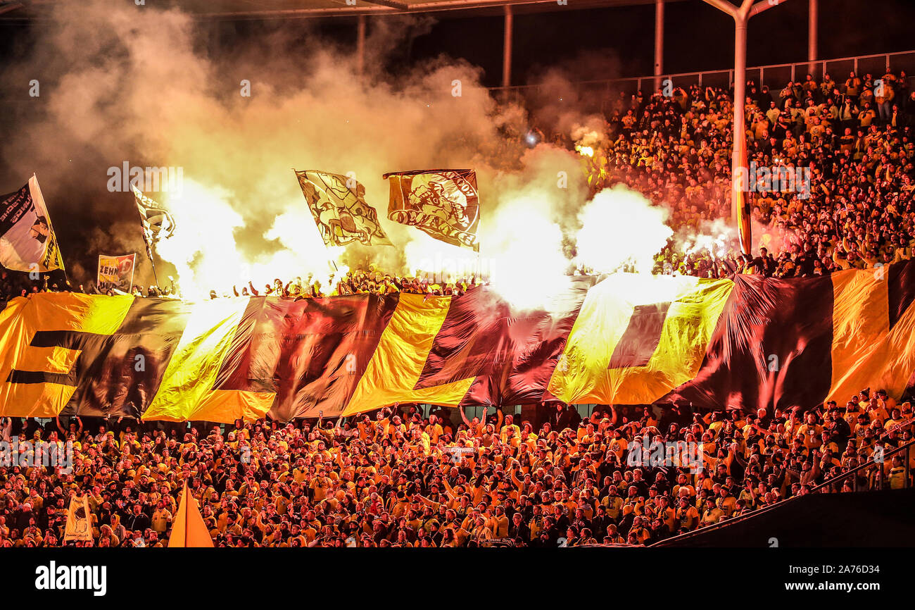30 October 2019, Berlin: Soccer: DFB Cup, Hertha BSC - Dynamo Dresden, 2nd  round, Olympic Stadium. Fans of Dynamo Dresden ignite Bengal fire. Photo:  Andreas Gora/dpa - IMPORTANT NOTE: In accordance with