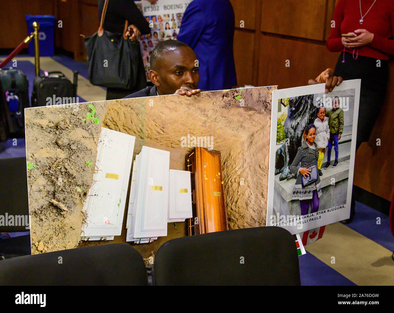 Washington, United States Of America. 29th Oct, 2019. Paul Njoroge, a father who lost his wife and three children in the crash of on Ethiopia Airlines Flight 302 holds photos of his children and their coffins in a grave prior to Dennis Muilenburg, President and Chief Executive Officer, The Boeing Company and John Hamilton, Vice President and Chief Engineer, Boeing Commercial Airplanes, giving testimony before the United States Senate Commerce, Science, and Transportation on 'Aviation safety and the future of Boeing's 737 MAX' on Capitol Hill in Washington, DC on Tuesday, October 29, 2019.Credi Stock Photo