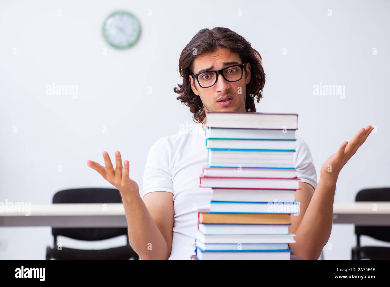 The young male student sitting in the classroom Stock Photo - Alamy