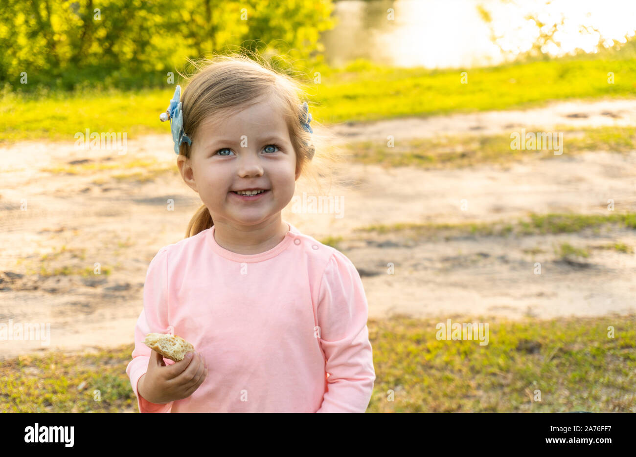 Smiling happy little girl in summer outdoor Stock Photo - Alamy
