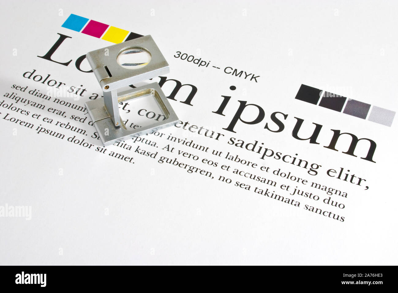 Magnifier on a test print sheet with 'lorem ipsum' blindtext checking Measurement and Color Management Stock Photo