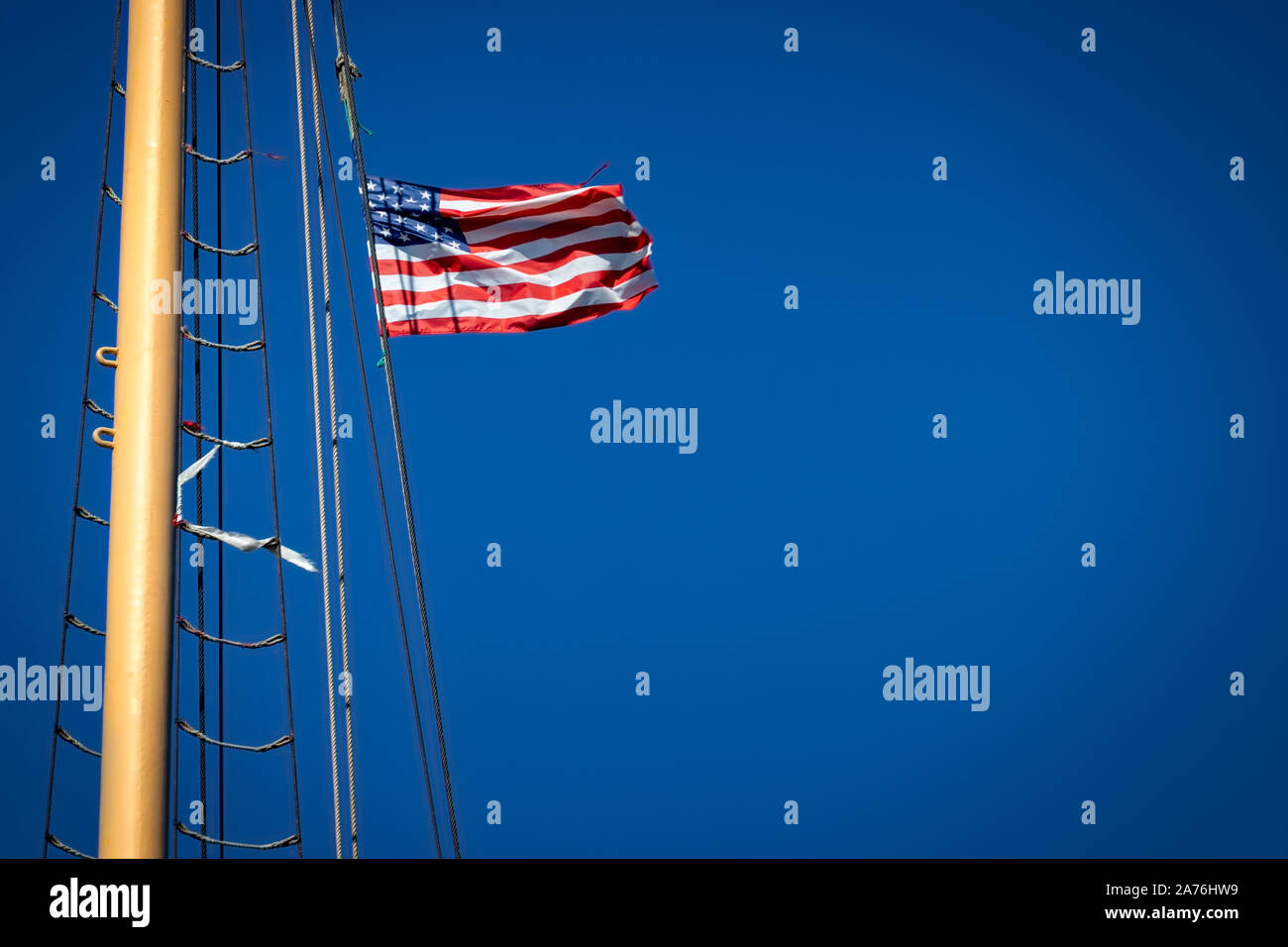 An American flag blowing in the wind on a ship in New York. Stock Photo