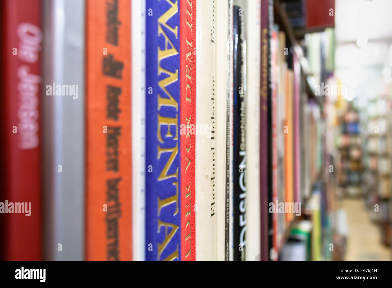 Books on a shelve in an antiquarian bookshop, close-up Stock Photo