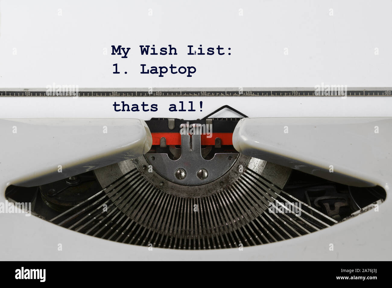 Christmas wish list written on an old typewriter with a single dot, a laptop. Concept for modernization and digitalization, selected focus, narrow dep Stock Photo