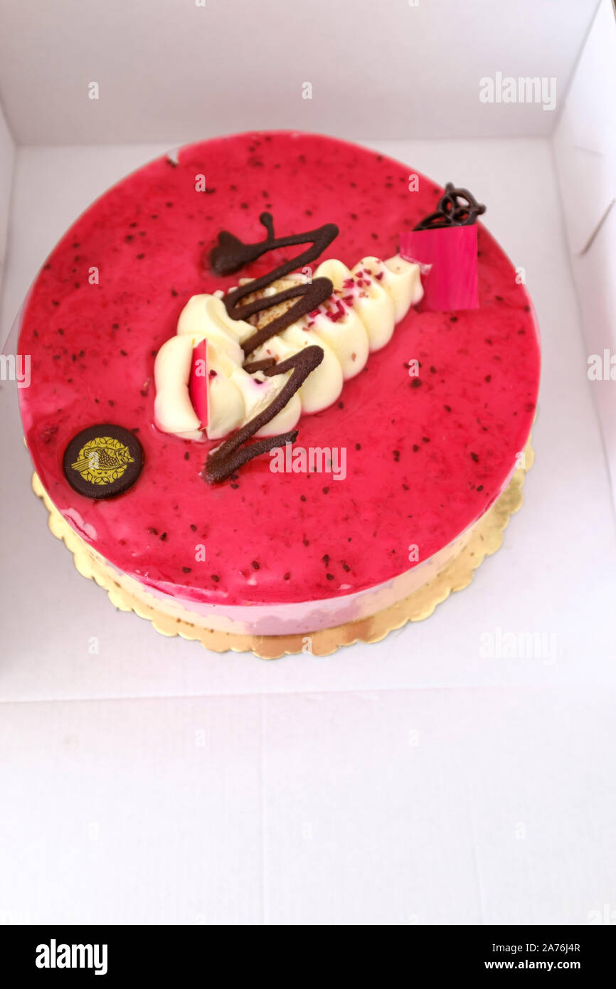 Rasberry Pavlova cheesecake with white marzipan and chocolate topping Stock Photo