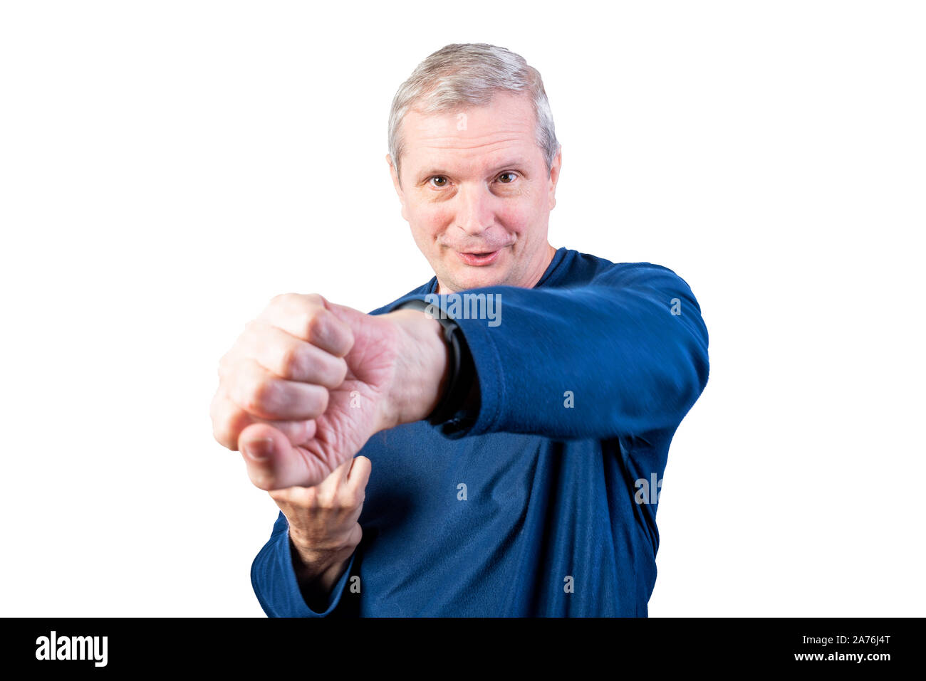 An elderly man demonstrates fist fight. Isolated on a white background. Stock Photo