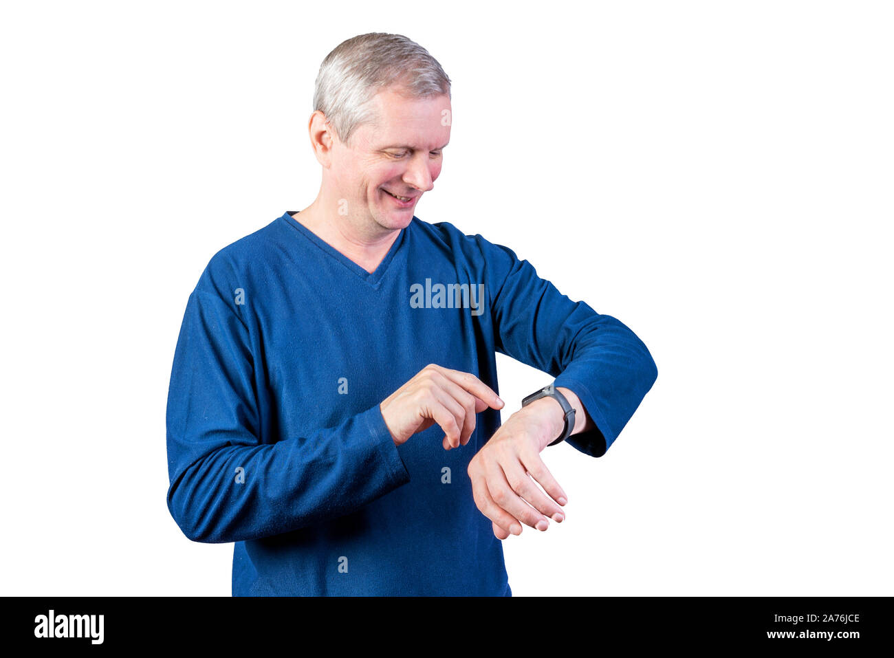 An elderly man measures the pulse of a fitness bracelet. Isolated on a white background. Stock Photo