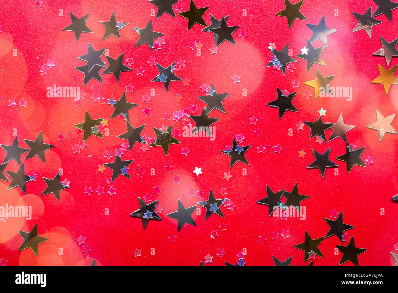 Gold stars on bright red background, abstract image Stock Photo