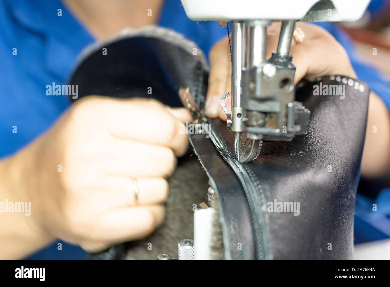 The process of sewing shoes on a sewing machine. Shoe production Stock