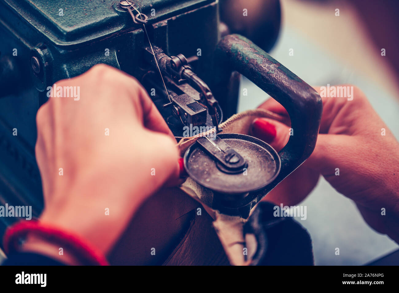 The process of sewing shoes on a sewing machine. Shoe production Stock