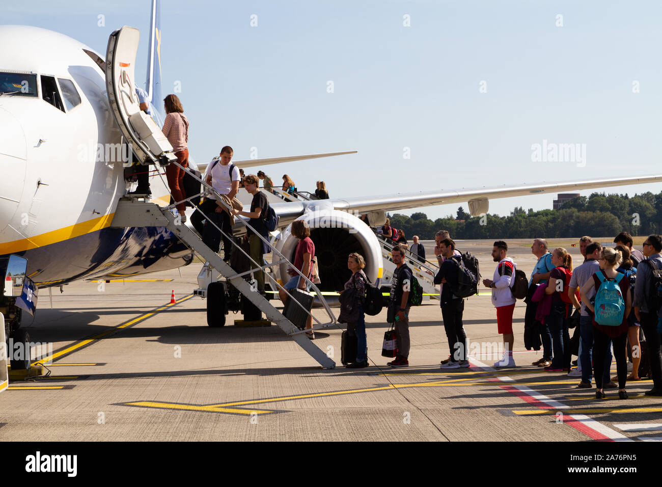 People boarding a Ryanair Boeing 737-800 aircraft at the Charleroi Airport in Belgium. Stock Photo