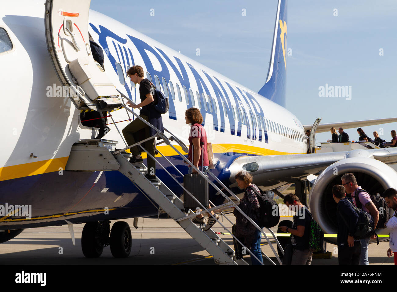 People boarding a Ryanair Boeing 737-800 aircraft at the Charleroi Airport in Belgium. Stock Photo